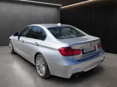 BMW 328i xDrive — Rear three-quarter view