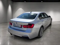 BMW 328i xDrive — Rear side view
